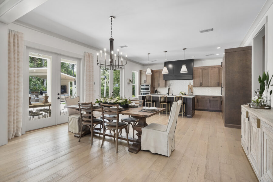 Modern open-concept kitchen and dining area with large windows, stylish cabinetry, and a central island, designed for family living and entertaining.
