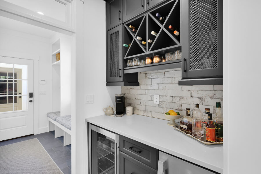 Wine storage cabinetry with black finish and wine bottle racks in a contemporary kitchen scene.
