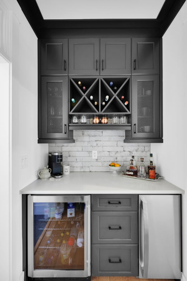 Wine storage cabinet with a countertop and beverage cooler in a modern home kitchen.