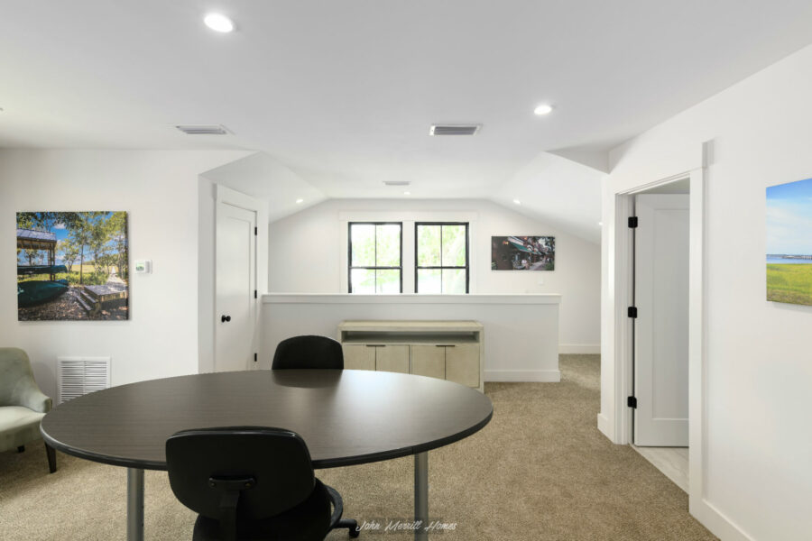 Modern home interior with white walls, large windows, and cozy furnishings in a bright and airy living space.