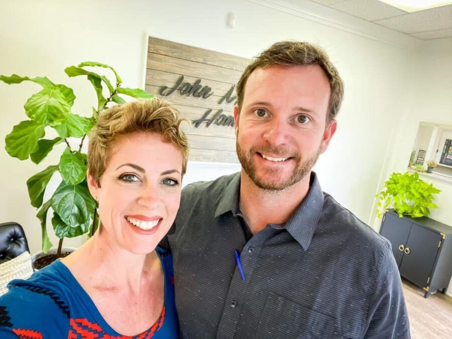 Friendly team members at John Merrill Homes office, showcasing professional environment and welcoming atmosphere.