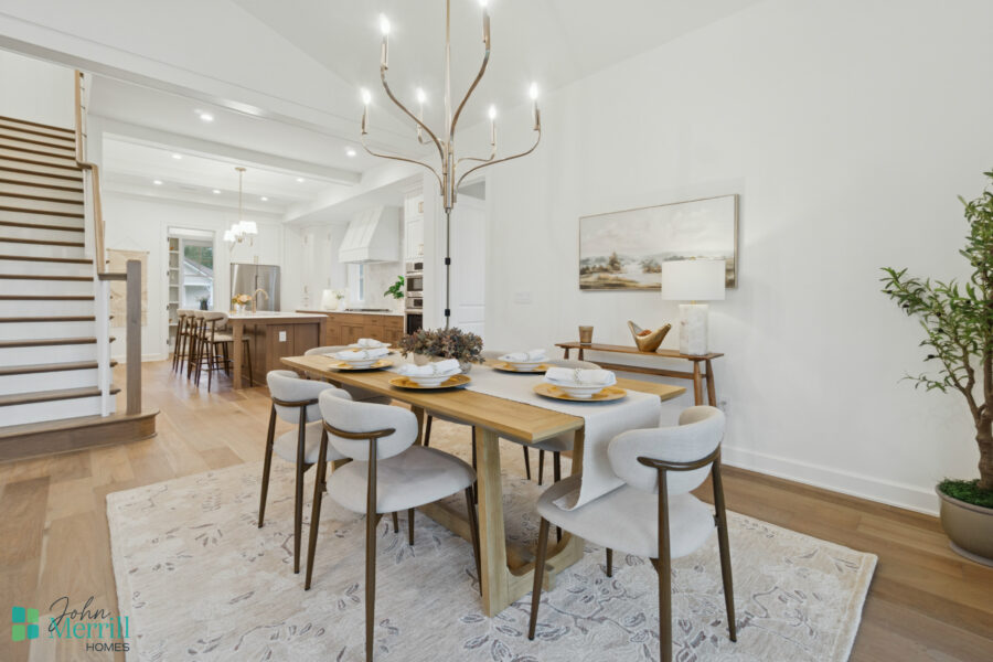 Bright and welcoming dining area with modern furniture, elegant chandelier, and seamless access to the open-concept kitchen in a beautifully designed home.