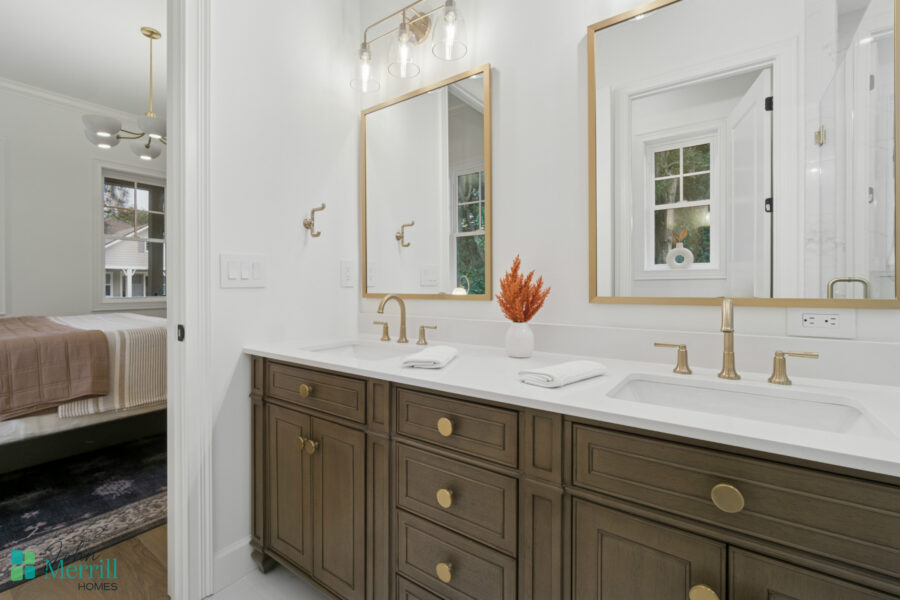Luxurious bathroom vanity with dual sinks, gold fixtures, and modern mirrors in a bright, elegant home interior. Perfectly designed for comfort and style in a modern residence.