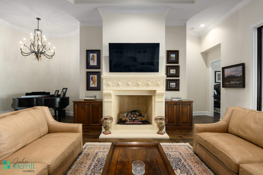 Bright and inviting living room with a modern fireplace, wall-mounted TV, and elegant decor.
