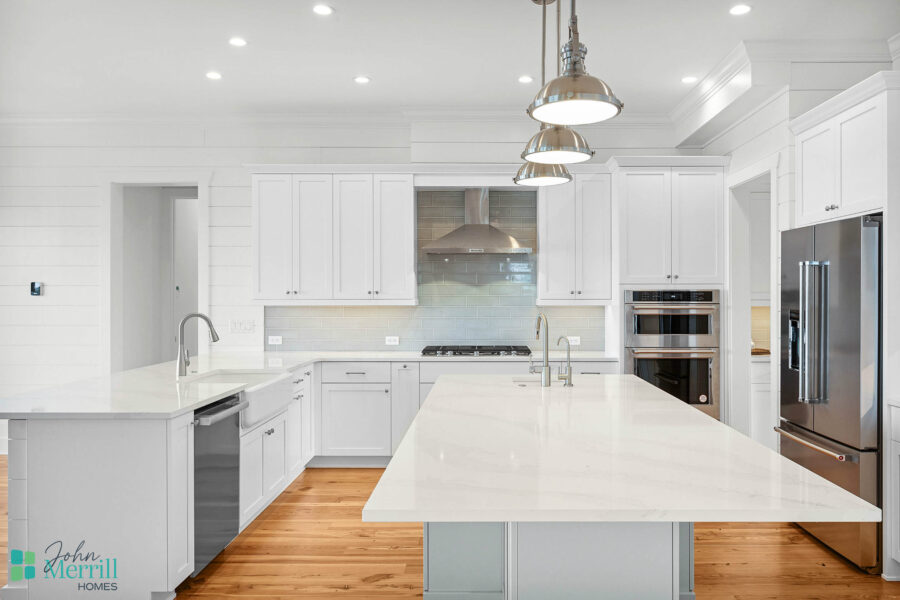 Bright, spacious kitchen featuring white cabinetry, a large island, and stainless steel appliances, perfect for cooking and entertaining.