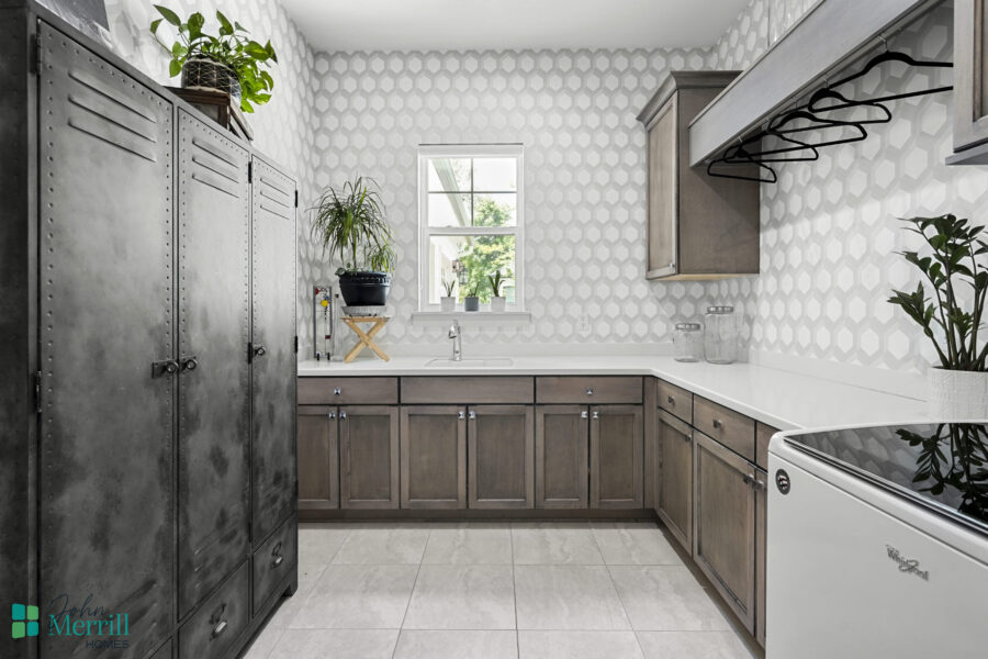 Bright kitchen featuring gray cabinets, white countertops, and a window with natural light.