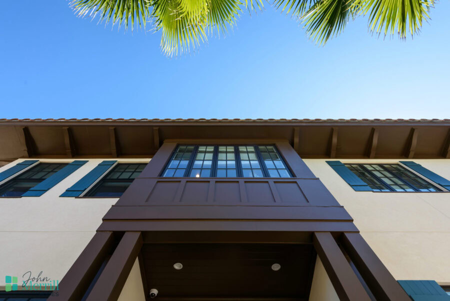Contemporary house exterior with large windows, brown accents, and a clean architectural design.