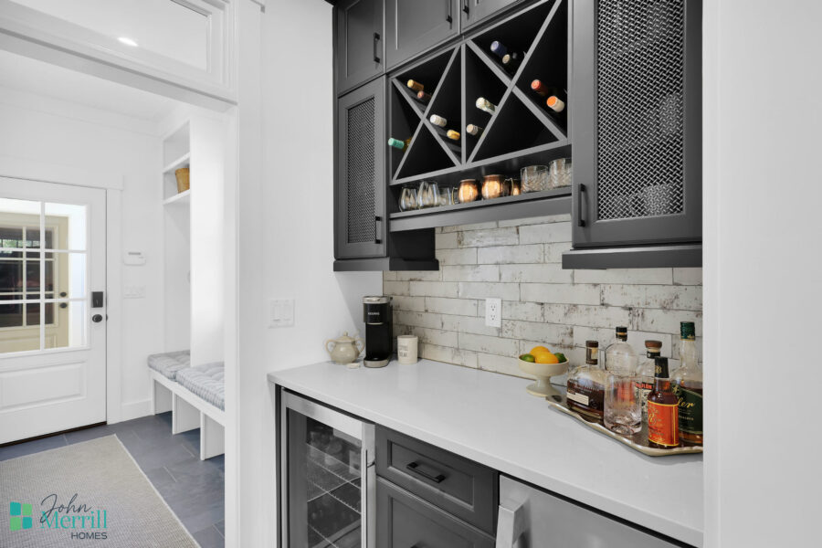 Stylish kitchen featuring built-in wine racks, a white countertop, and a brick backsplash, perfect for entertaining and everyday use.
