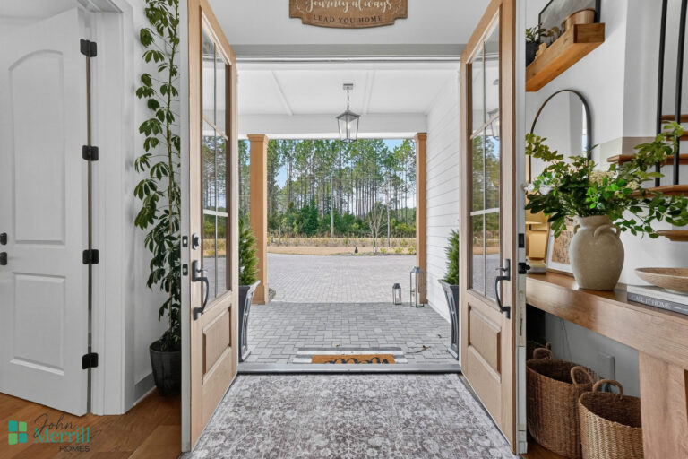Bright, welcoming entrance with natural light and greenery outside.