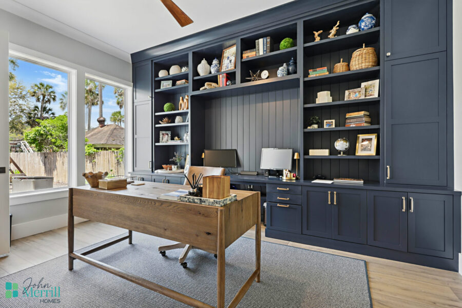 Bright and stylish workspace featuring custom cabinetry, ample natural light, and organized shelving for a productive lifestyle.