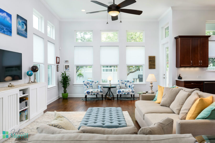 Bright living room with large windows, white walls, and contemporary furniture.