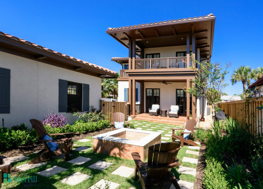 Beautiful two-story home featuring a spacious balcony and inviting backyard with seating area and fire pit. Perfect for outdoor entertaining and relaxing in a sunny climate.
