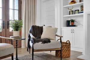 Interior design trends 2026, chair with pillow and blanket