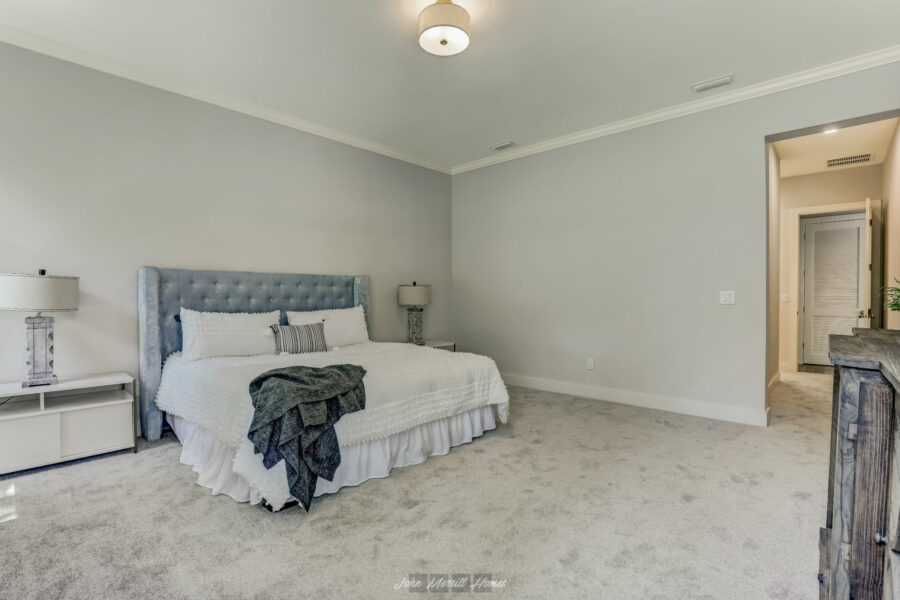 Master bedroom with a plush bed, light-colored walls, and elegant decor showcasing a comfortable and modern interior design.